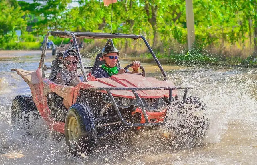 Buggy splashing through a muddy trail